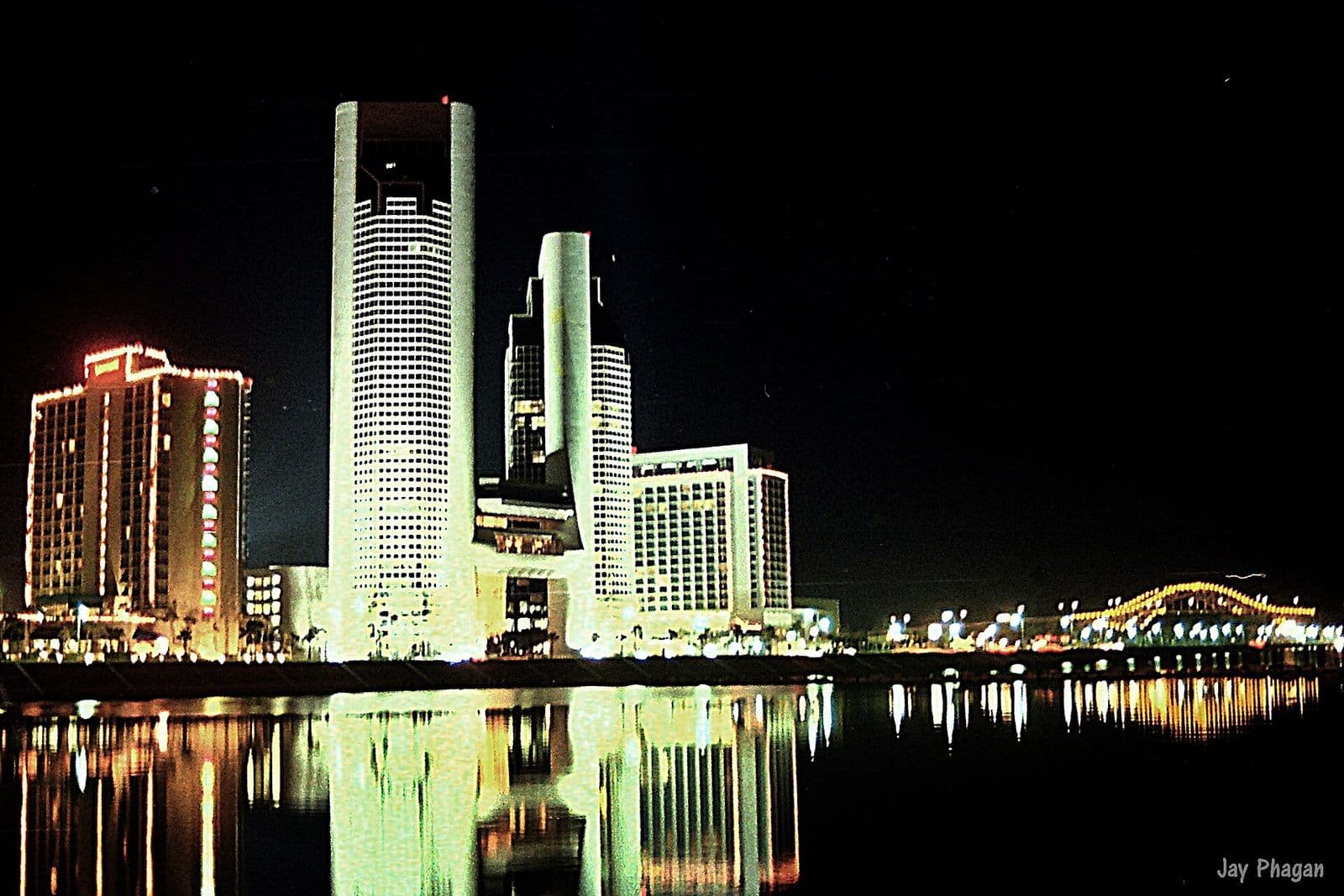 Downtown Corpus Christi towers lit up and reflected in the bayfront at night